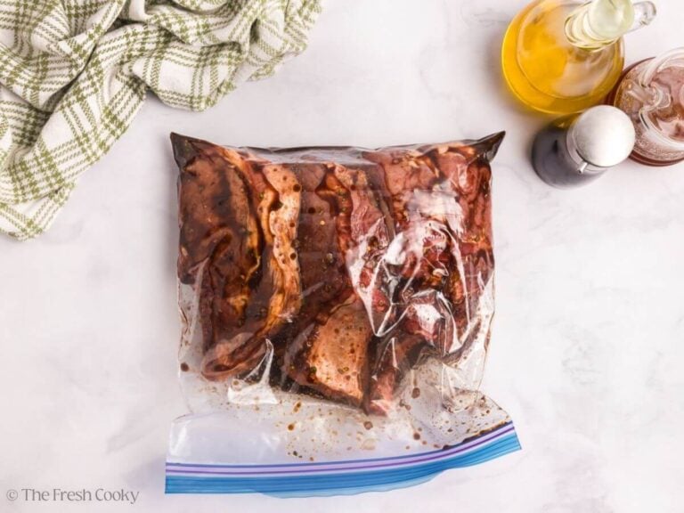 Pork chops in a bag mixed together with the marinade.