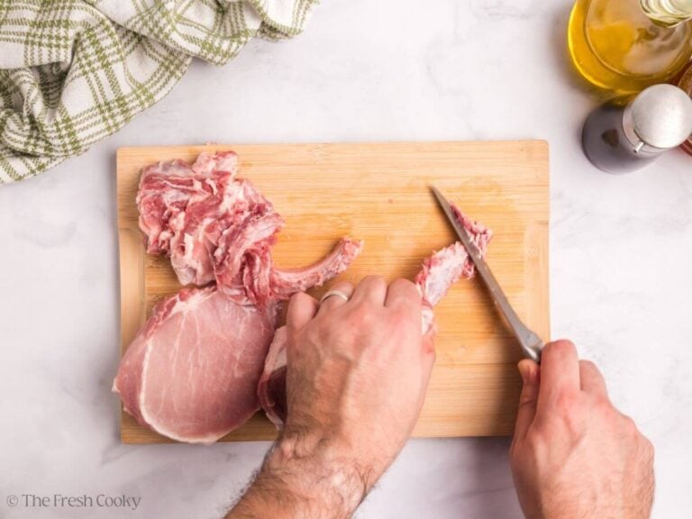 Slice off the soft end of the pork chop at the very tip of the bone.