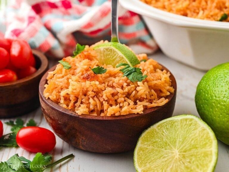 Small bowl of Spanish rice garnished with cilantro and a lime wedge.