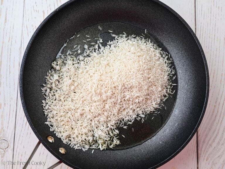 Rice in a skillet with oil.
