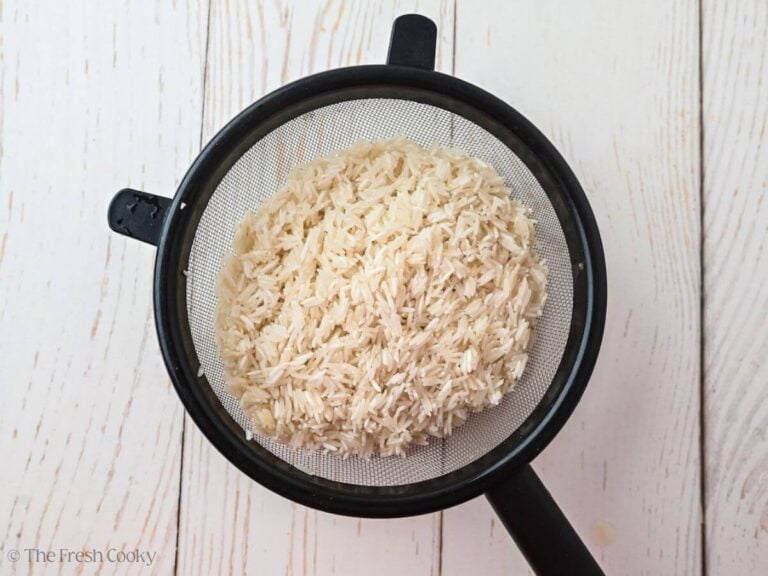 Rice rinsed in a fine mesh sieve.