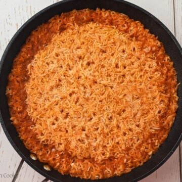 Cooked rice in a skillet after water has been evaporated.