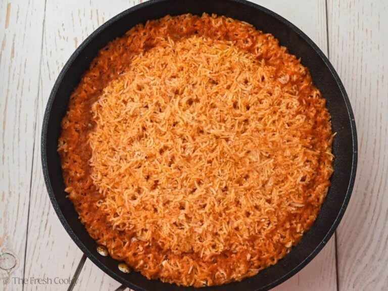Cooked rice in a skillet after water has been evaporated.