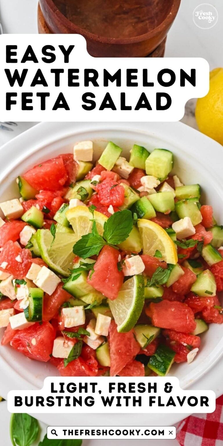 Feta, watermelon, cucumber salad in a white bowl, topped with mint and basil and a honey lime dressing, to pin.