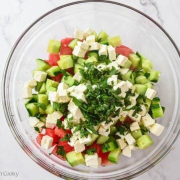 Watermelon, cucumber, feta, and mint in a large bowl.