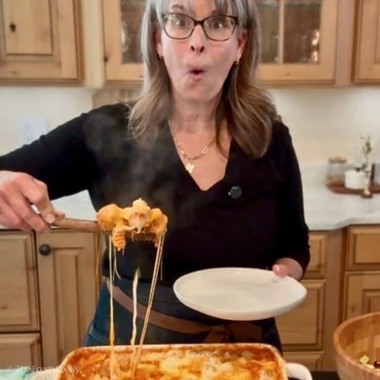 Kathleen (The Fresh Cooky) with cheesy stringy serving of meatball casserole about to plate it.