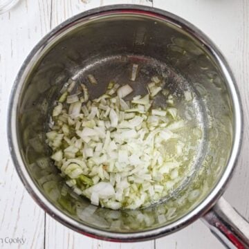 Chopped onion added to the melted butter in a saucepan.
