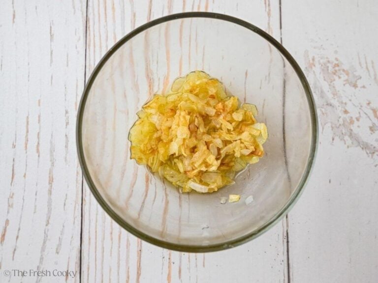 Caramelized onions set aside in a bowl.