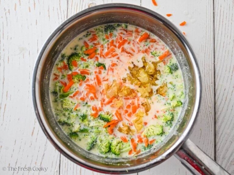 Vegetables placed in the milk mixture in a pot.