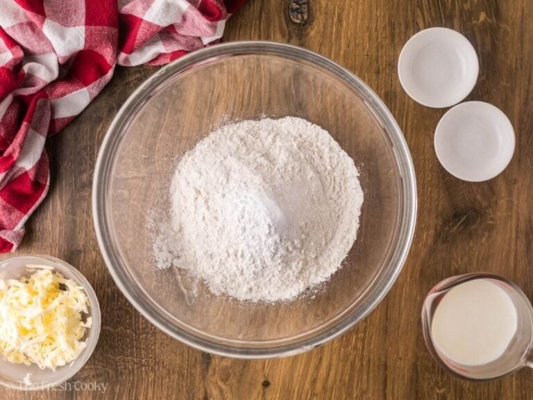 Baking powder and salt added to the bowl of flour.