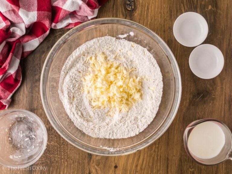 Grated cold butter in a bowl of flour.