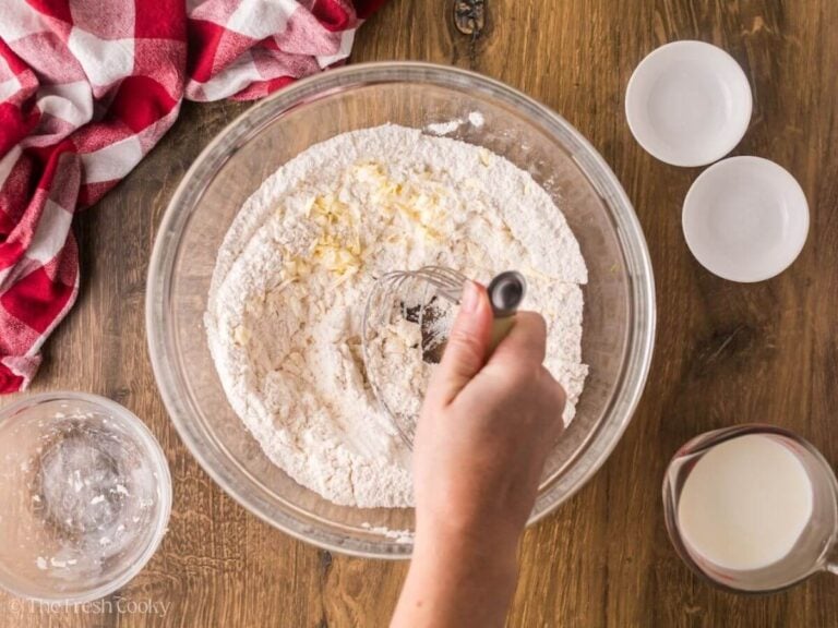 Whisking together the butter and dry ingredients.