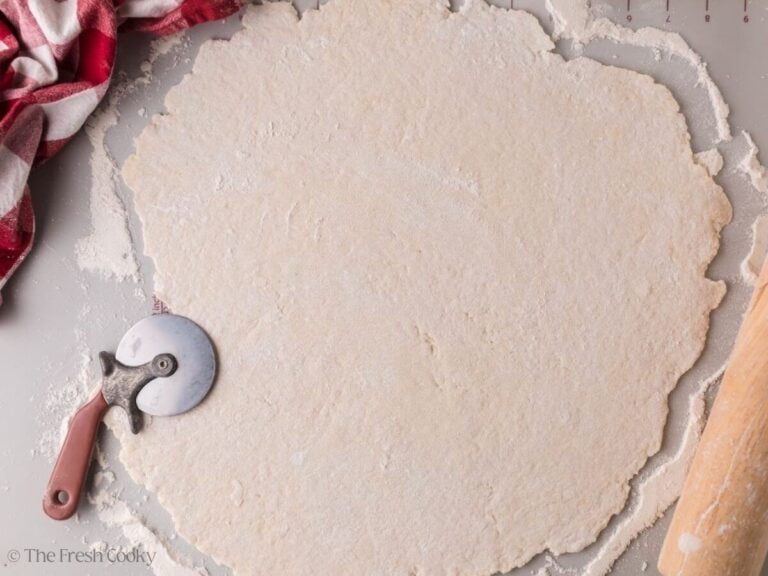 Rolled out dumpling dough on a floured surface.