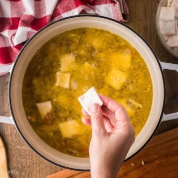 Square dumplings added to the chicken soup.