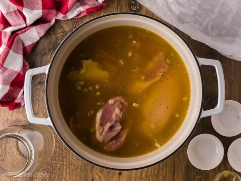 Chicken added to the pot of broth and vegetables.