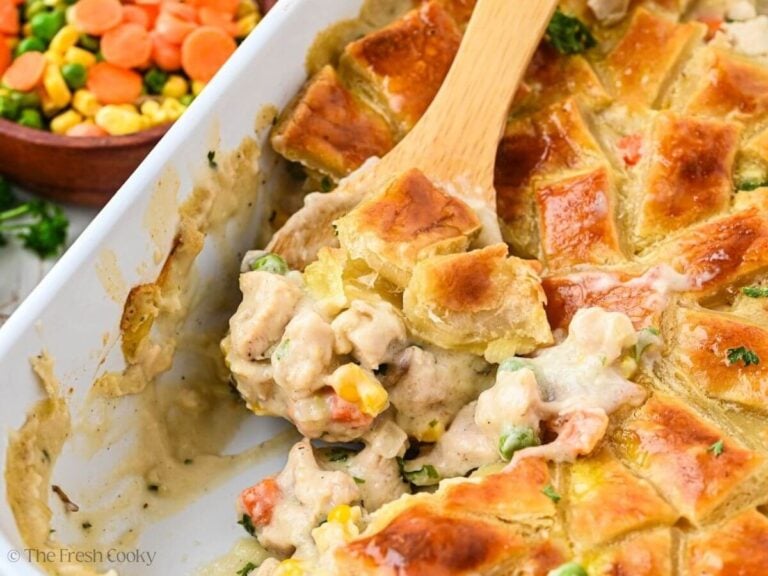 Wooden spoon in a chicken poe pie in a baking dish.