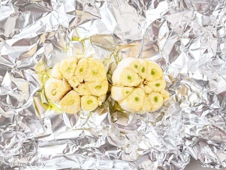 Two bulbs of garlic in foil.