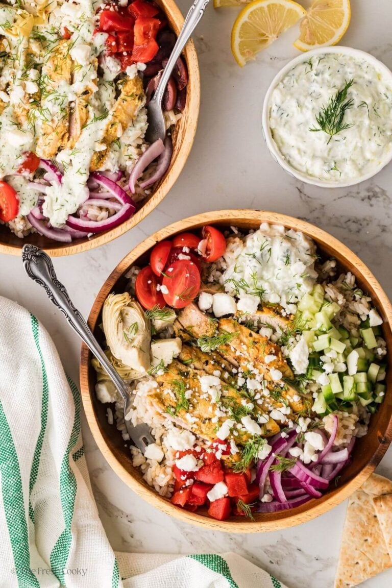 Overhead shot of two Greek chicken bowls with chicken and veggies.
