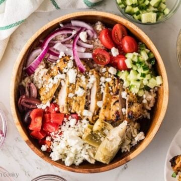 Feta placed on top of the Greek chicken bowl.