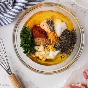 Ingredients for marinade in a glass bowl, ready to whisk.
