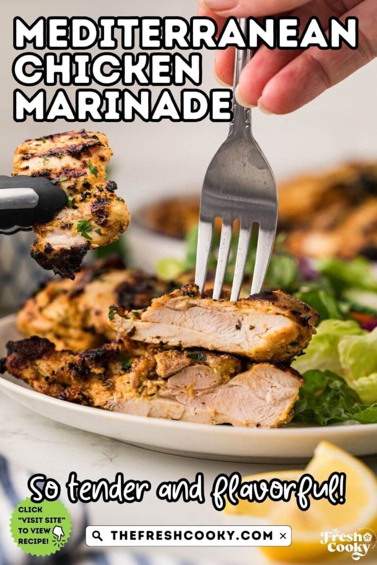 A fork grabbing a juicy bite of grilled Greek chicken thighs on a plate with a green salad, to pin.