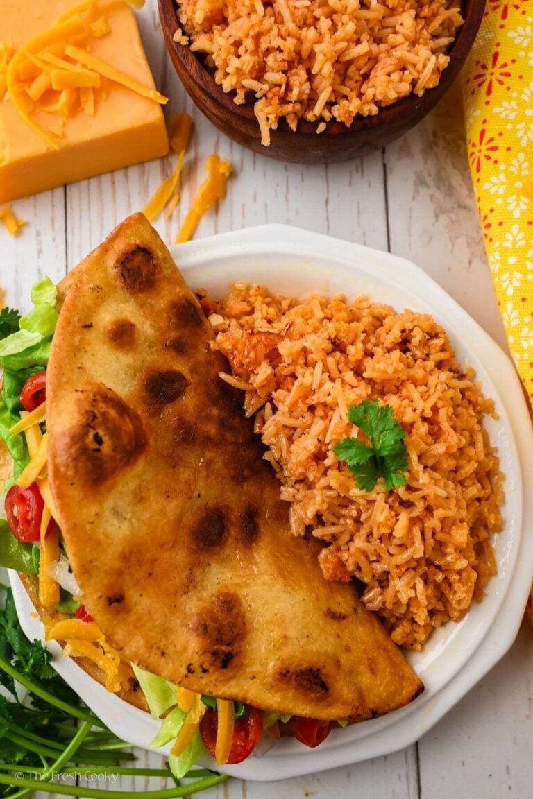 Overhead shot of a plate with a ground beef taco and Mexican rice.