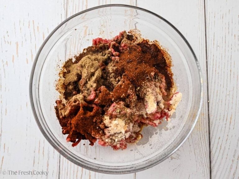 Ground beef with spices on top in a bowl.