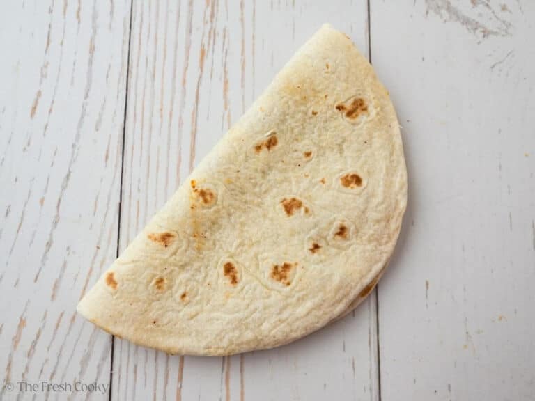 Tortilla folded over the ground beef mixture in the tortilla.