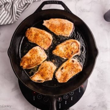 Pork chops flipped to the other side to sear.