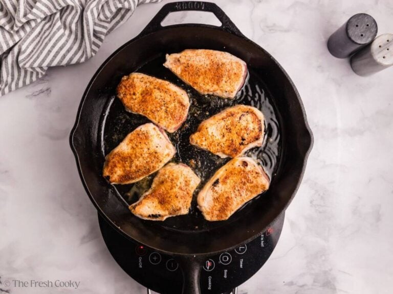 Pork chops flipped to the other side to sear.