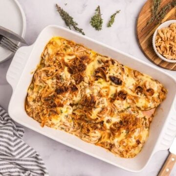 Baked pork chop casserole in a white baking dish.