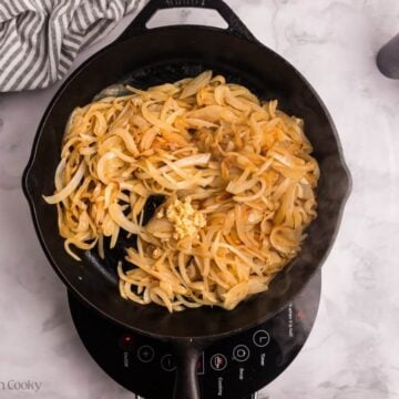Caramelized onions in a skillet with garlic.
