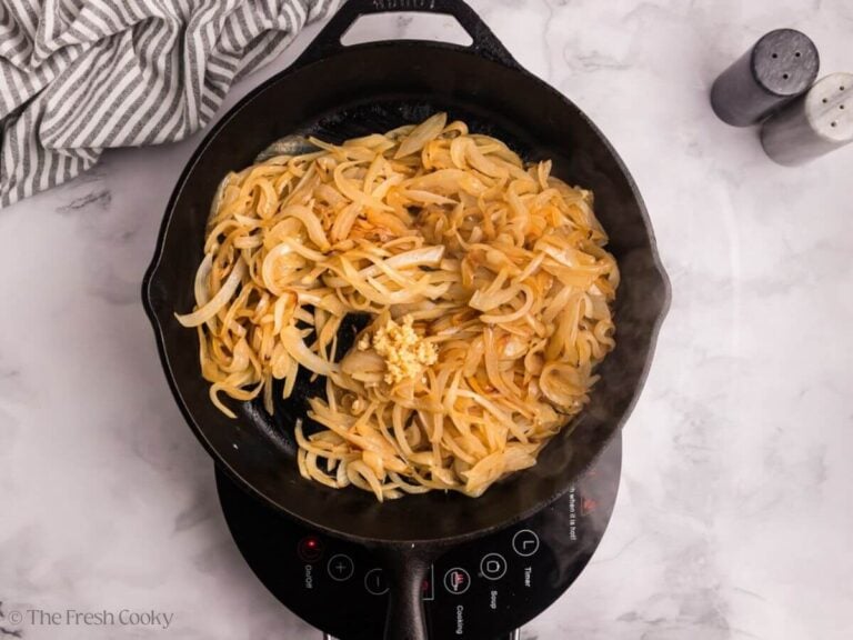 Caramelized onions in a skillet with garlic.