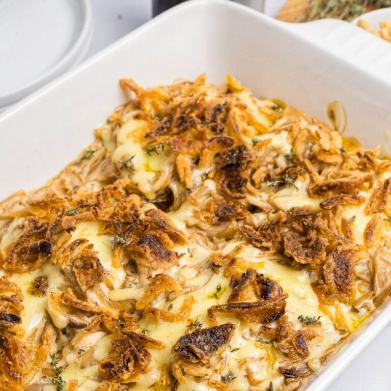 Pork chop casserole with crispy onions in a white baking dish.