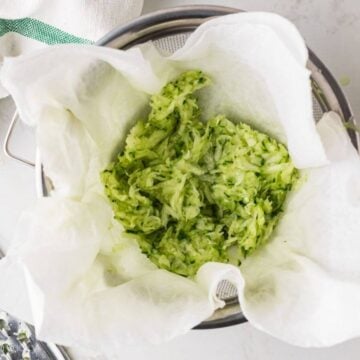 Grated and squeezed cucumber in paper towels.