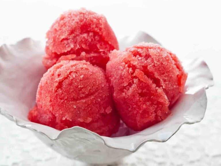 Three scoops of frozen watermelon sorbet in a pretty serving cup.