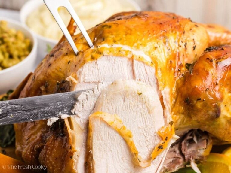 Side view of carving into an herb butter turkey.