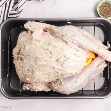 Herb butter turkey with the compound butter spread on top.