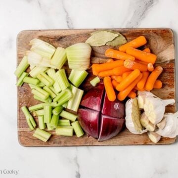 Fresh vegetables chopped up on a wooden board.