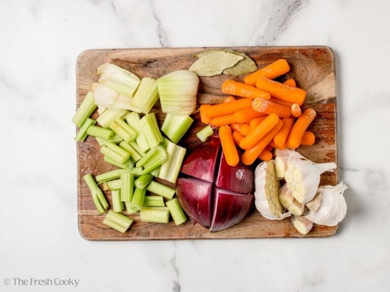 Fresh vegetables chopped up on a wooden board.
