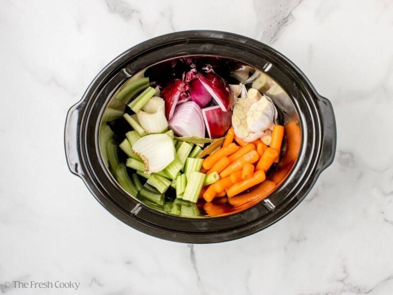 Chopped veggies placed in the slow cooker.