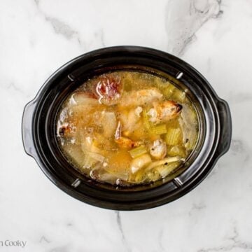 Broth cooking in a slow cooker before being strained.
