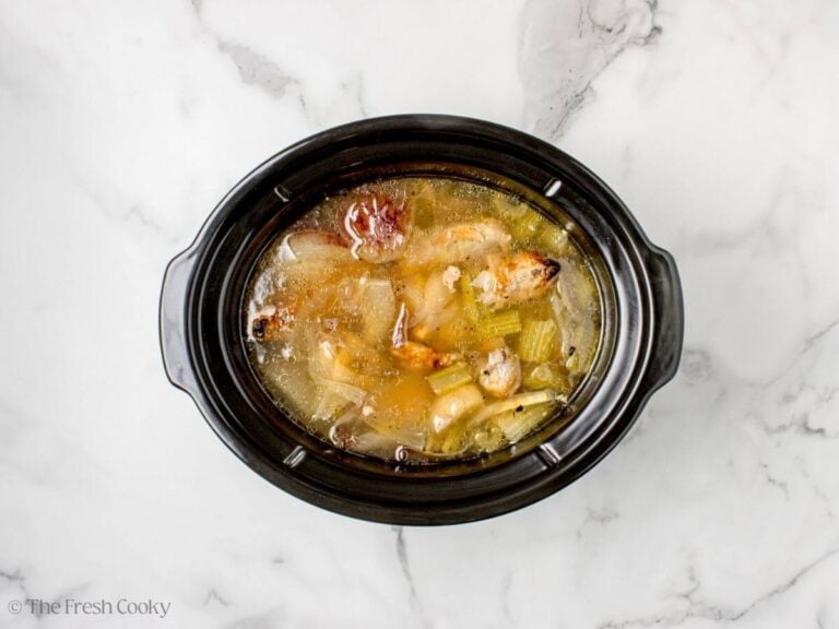 Broth cooking in a slow cooker before being strained.