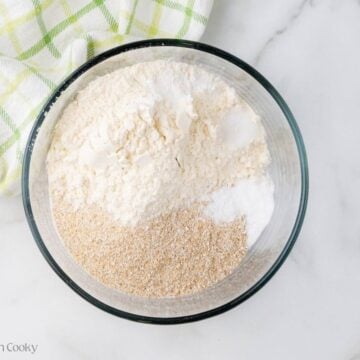 Dry ingredients like flour, bran, baking soda, baking powder and salt in a bowl.
