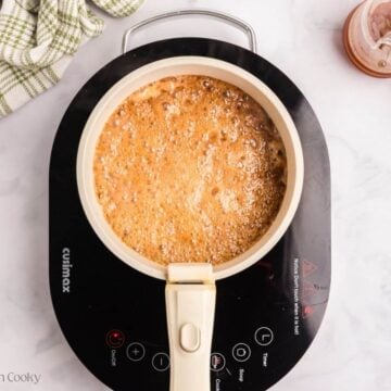 Bringing glaze to a low simmer in saucepan.