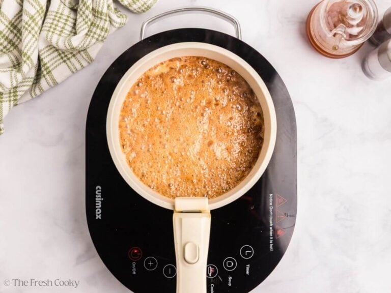 Bringing glaze to a low simmer in saucepan.