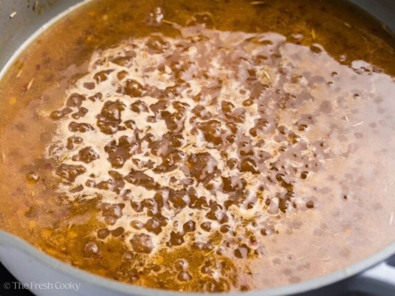 Close up of a maple glaze simmering in a skillet.