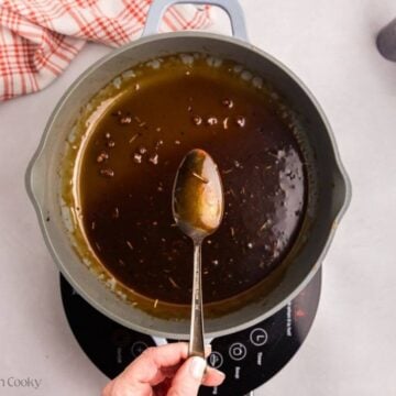 Spoon coated with maple glaze to show that it is ready.