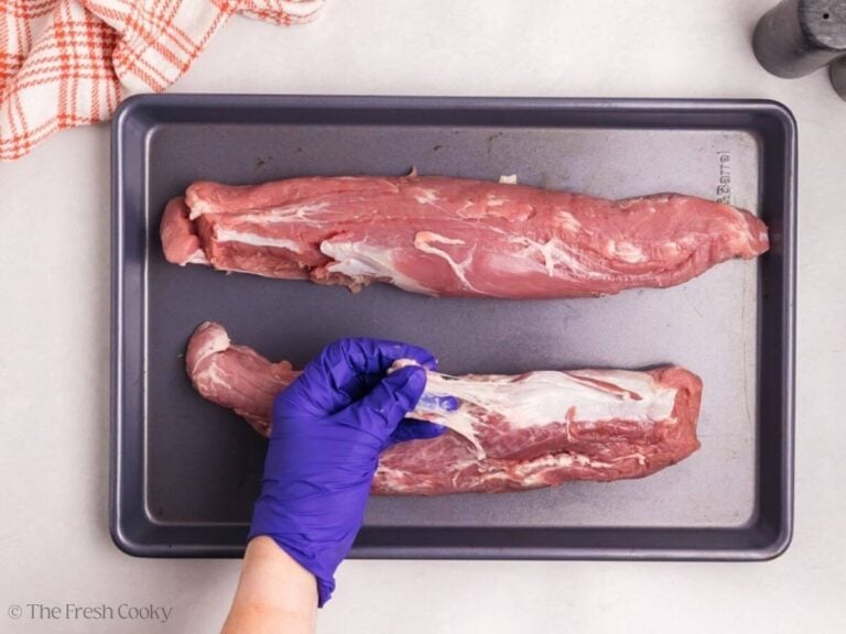 Hand trimming the silver skin off a pork tenderloin.