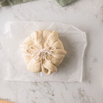 Brie all tied up with string to form the pumpkin shape.